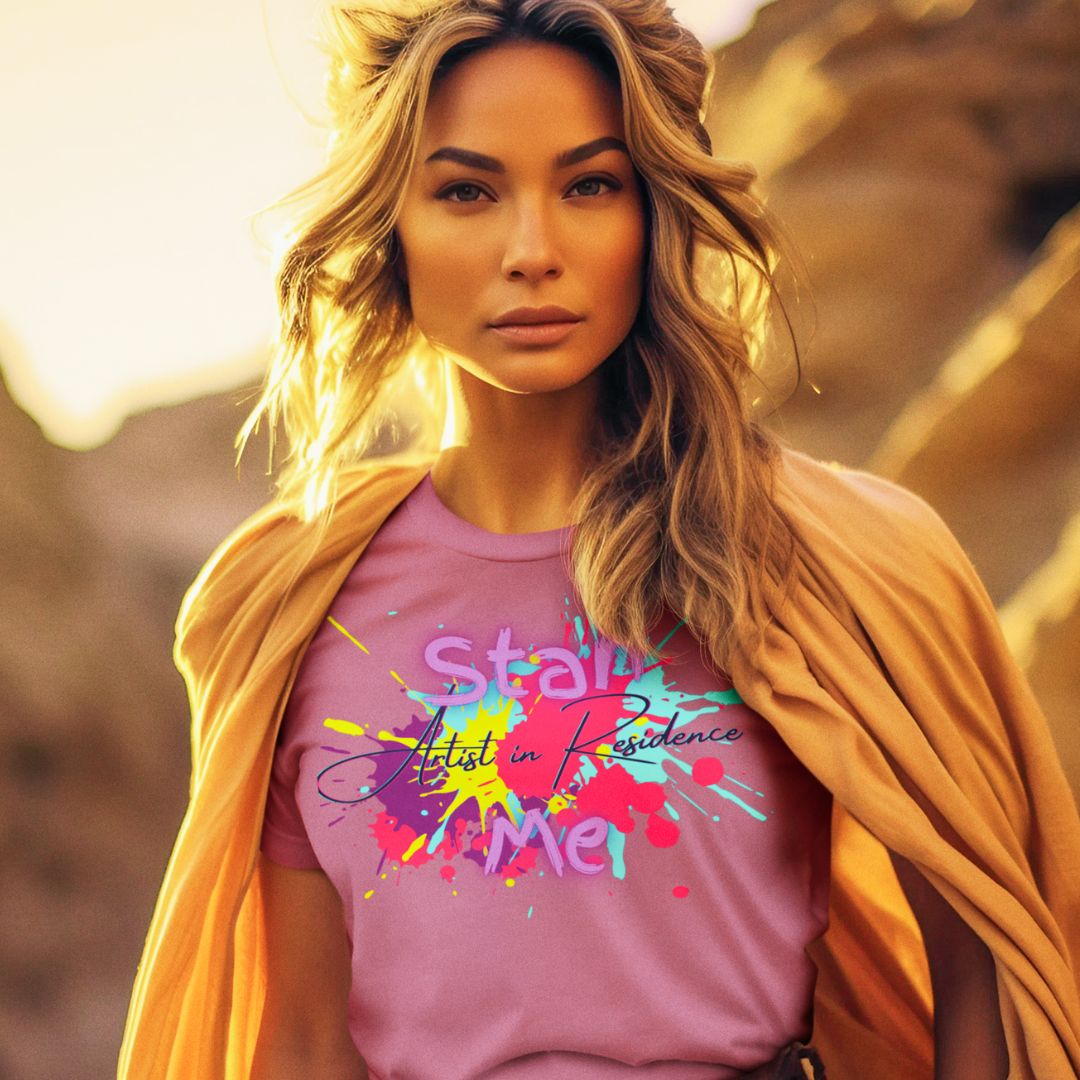 “Stan Me, Artist in Residence” tees featuring paint splatter designs, blending artistic creativity with stan culture. Available in 8 unique styles. Perfect for artists looking to attract fans and gigs. Mauve tee
