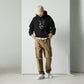 A stylish black and white Heavyweight Be the Light Unisex Hoodie displayed against a backdrop of creativity. The bold graphics symbolize authenticity, inviting artists to embrace their vision and be the light for their audience.