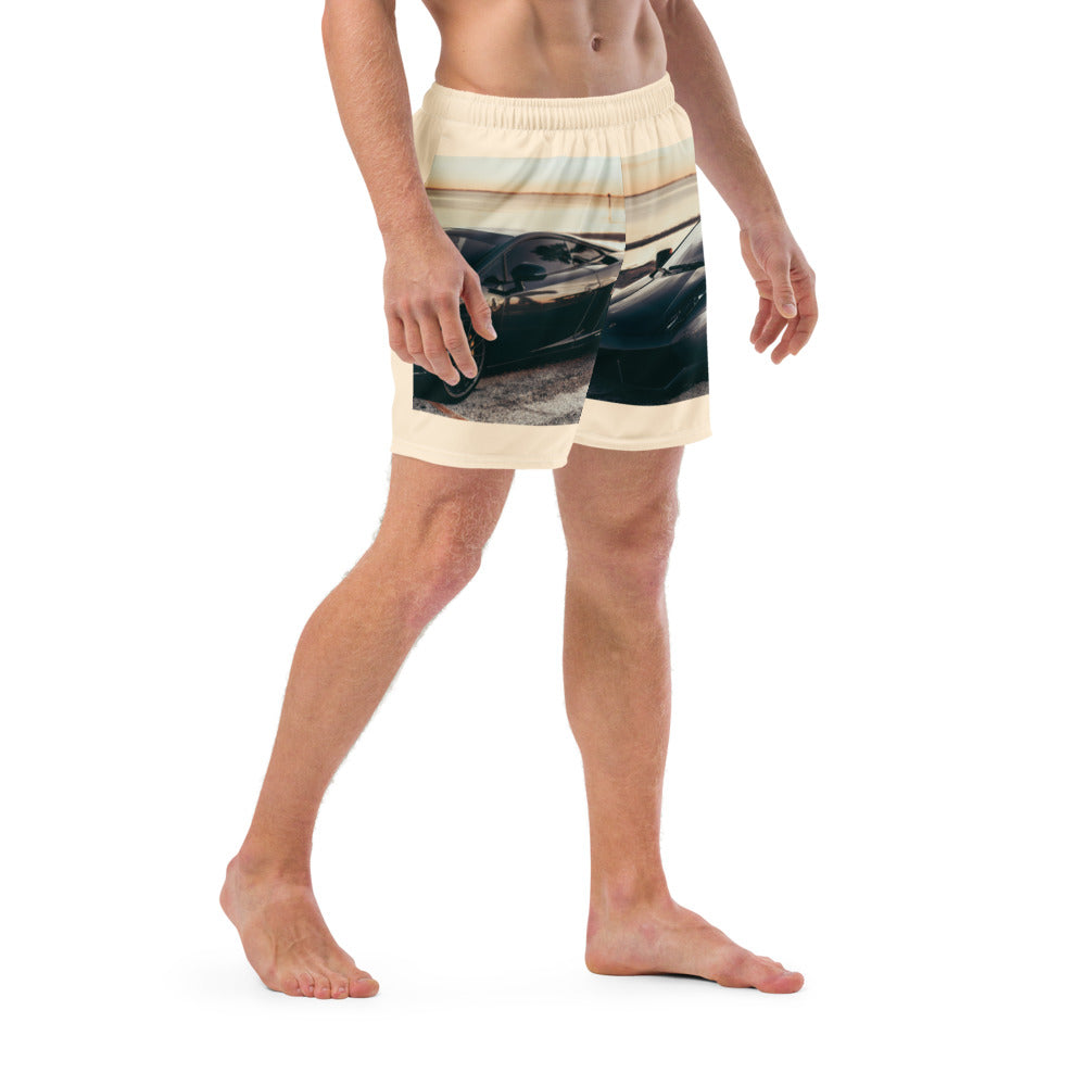 Male artist confidently stands out in vibrant race car swim trunks from SpotlYght Seeker, symbolizing success and creative expression. Skrrt your way to style and savings!